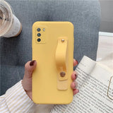 a woman holding a yellow phone case with a phone holder