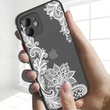 a woman holding an iphone case with a white lace pattern on it