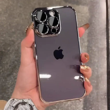 A woman holding an iphone with a ring on it