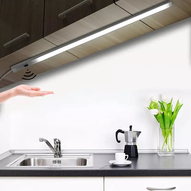 a woman is pointing at a kitchen sink