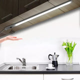 A woman is pointing at a kitchen sink