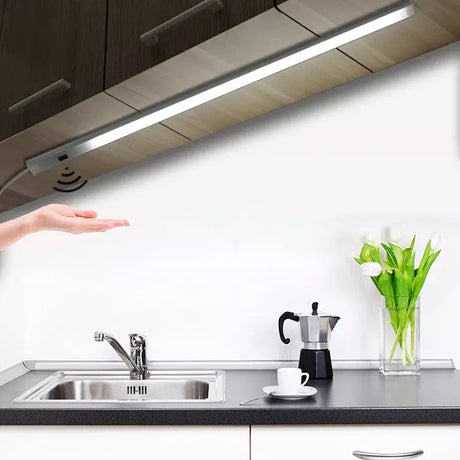 A woman is pointing at a kitchen sink