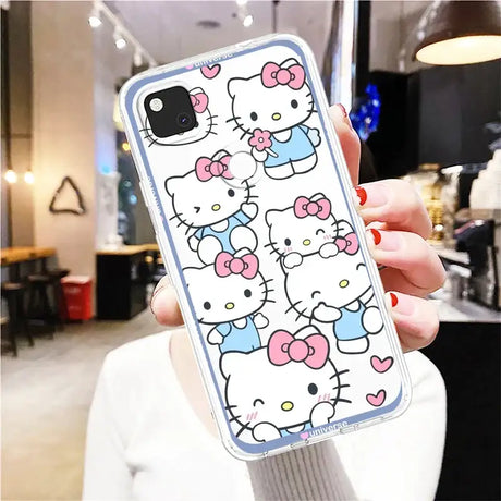 A woman holding a hello kitty phone case