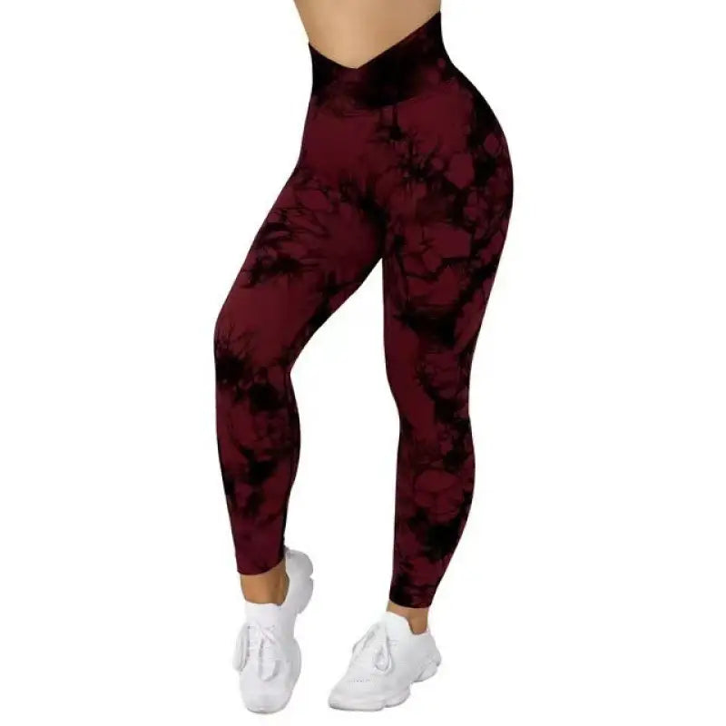 a woman in a maroon and black tie dye leggings