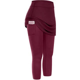 a woman wearing a maroon leggings with a white waistband
