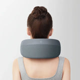 a woman wearing a neck pillow