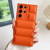 A woman holding an orange iphone case