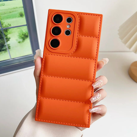 A woman holding an orange iphone case