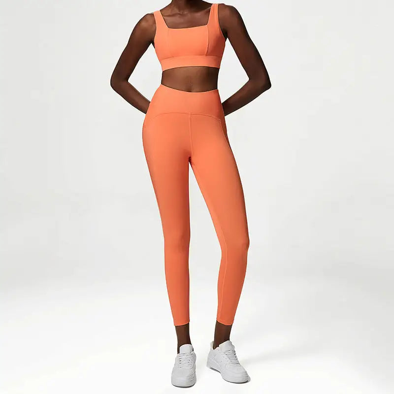 a woman in an orange sports bra top and leggings