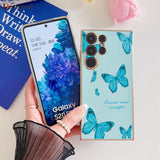 a woman holding a phone with a blue butterfly design on it