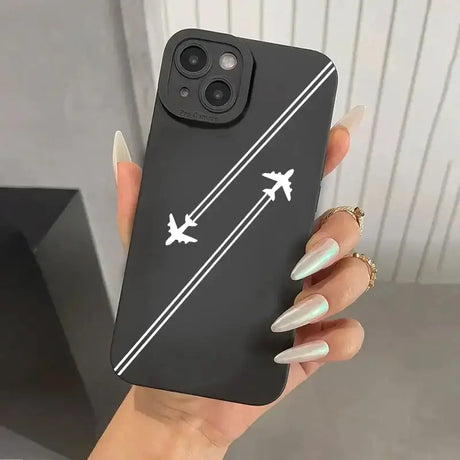 A woman holding a phone case with an airplane on it