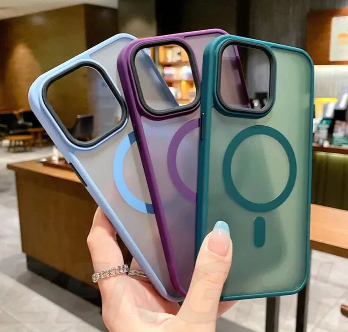 a woman holding up a phone case with a phone in the background