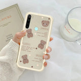 a woman holding a phone case with a bear design