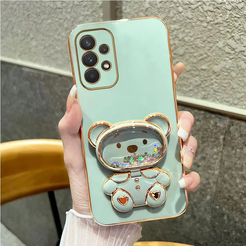 a woman holding a phone case with a bear