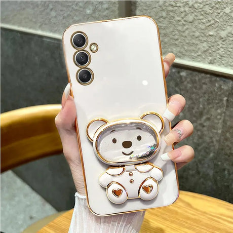 a woman holding a phone case with a bear