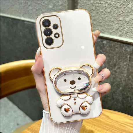 a woman holding a phone case with a bear