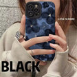 A woman holding a phone case with a black flower pattern