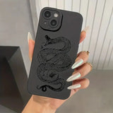 a woman holding a phone case with a black snake on it