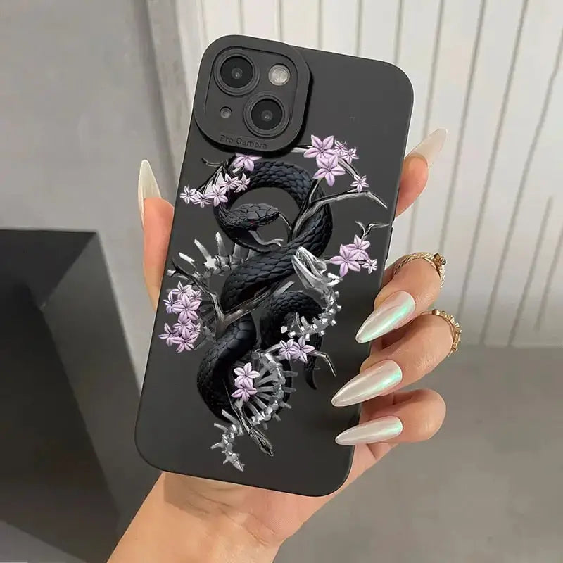 a woman holding a phone case with a black dragon on it