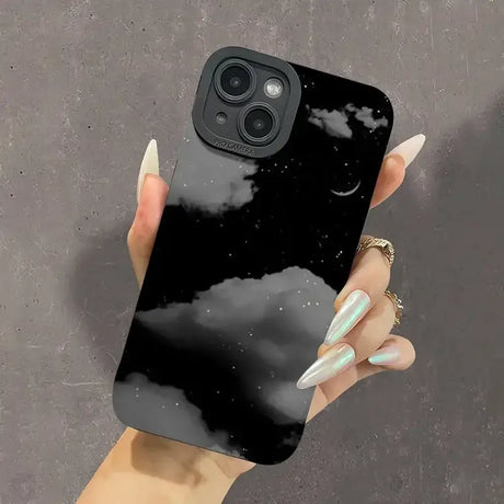 A woman holding a phone case with a black sky and stars