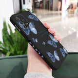 a woman holding a phone case with a blue butterfly pattern