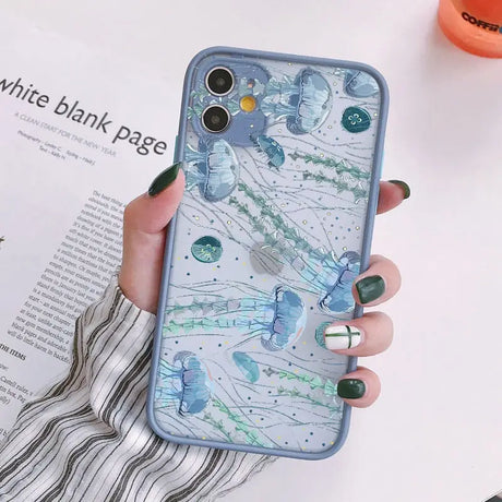 A woman holding a phone case with a blue and green marble pattern