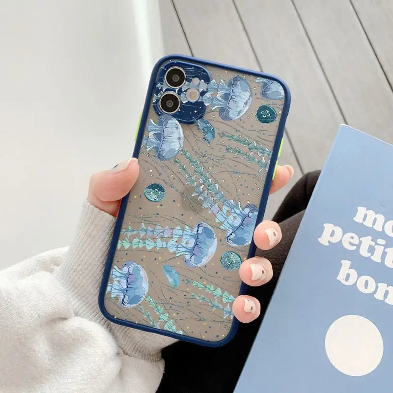 a woman holding a phone case with a blue flower design