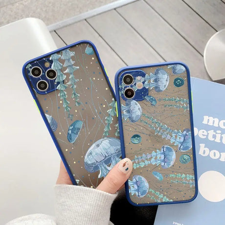 A woman holding a phone case with blue flowers on it