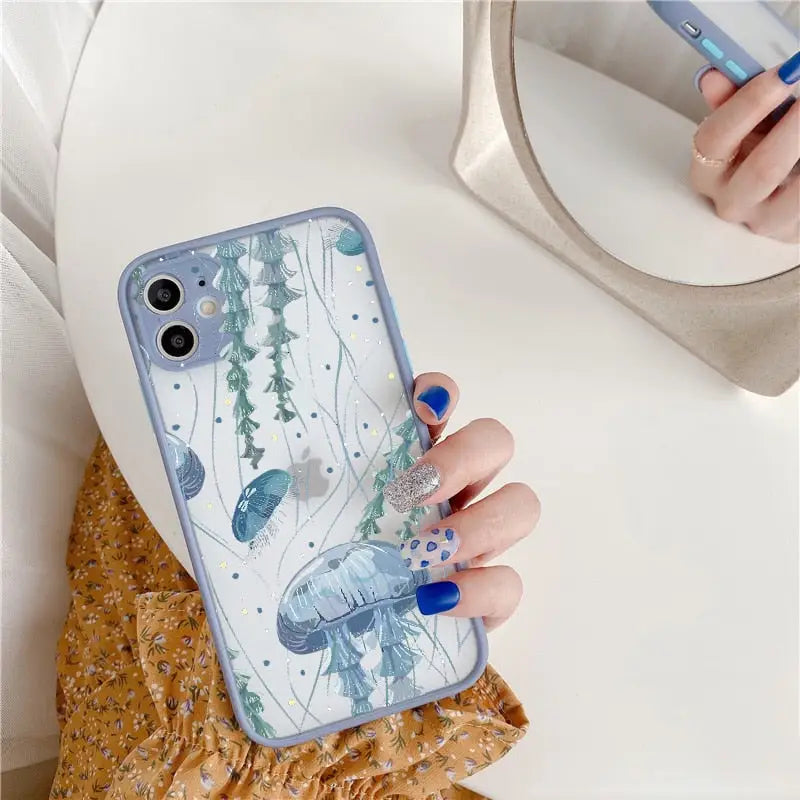 a woman holding a phone case with a blue and white floral design