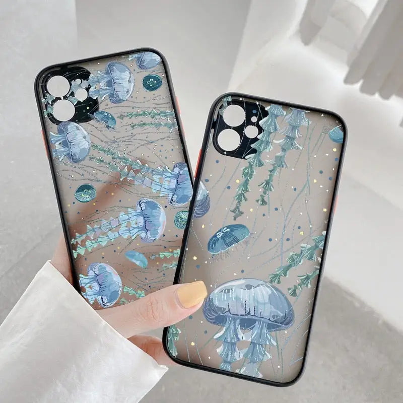a woman holding a phone case with a blue jelly fish on it