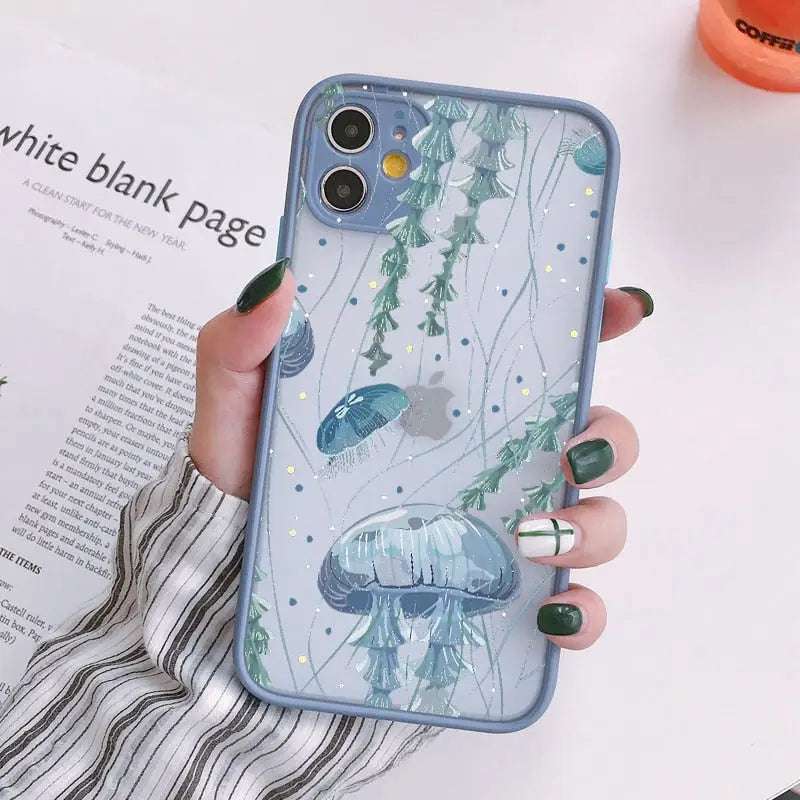 a woman holding a phone case with a blue fish pattern