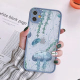 a woman holding a phone case with a blue fish pattern