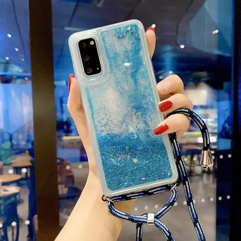 a woman holding a phone case with a blue liquid liquid