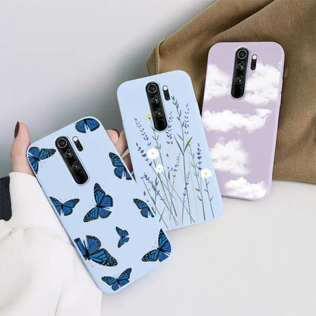 A woman holding a phone case with blue butterflies on it