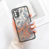 A woman holding a phone case with blue leaves on it