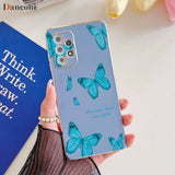 a woman holding a phone case with blue butterflies on it