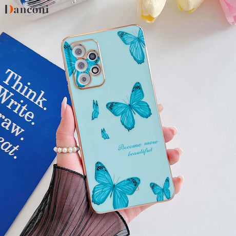 a woman holding a phone case with blue butterflies on it