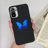 a woman holding a phone case with a blue butterfly on it