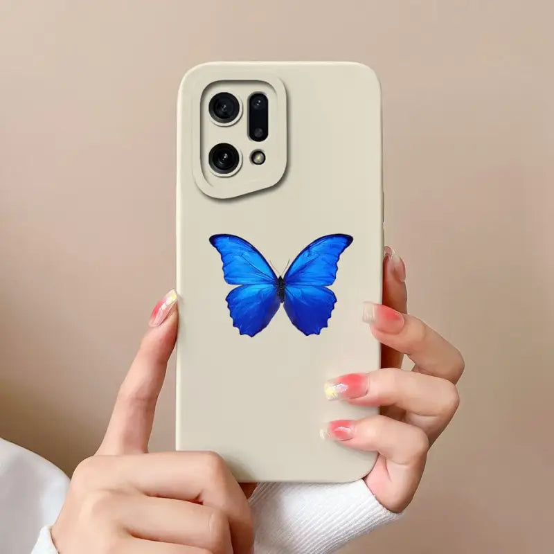 a woman holding a phone case with a blue butterfly on it