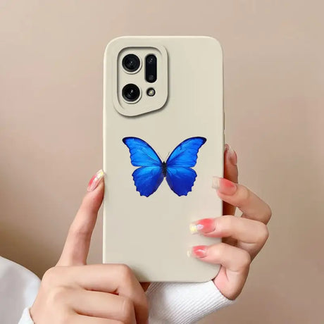 a woman holding a phone case with a blue butterfly on it