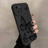 a woman holding a phone case with butterflies on it