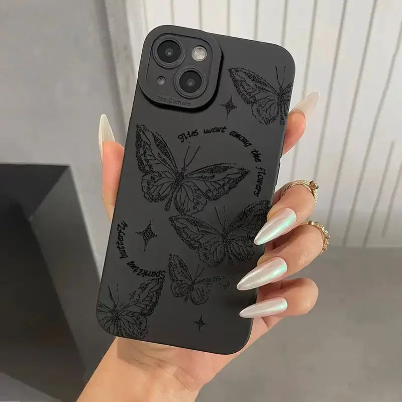 a woman holding a phone case with butterflies on it