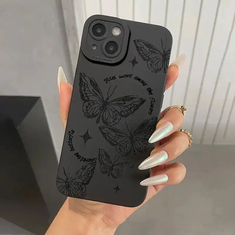 A woman holding a phone case with butterflies on it