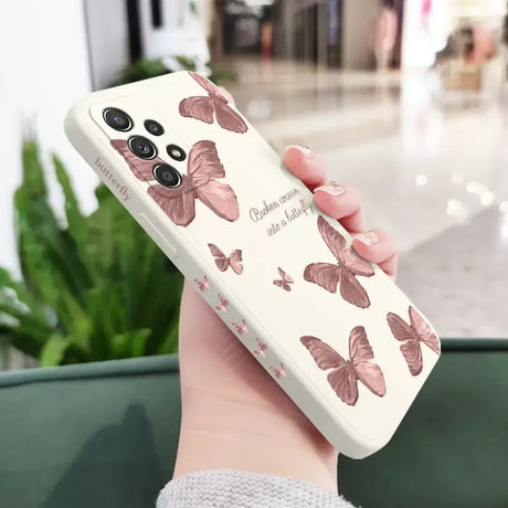 A woman holding a phone case with butterflies on it