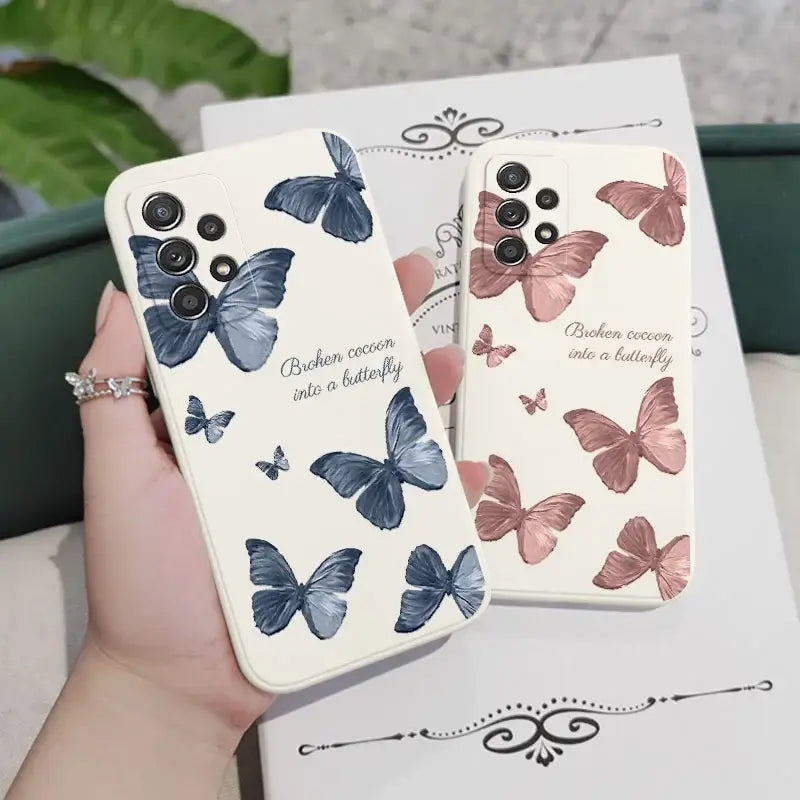 a woman holding a phone case with butterflies on it