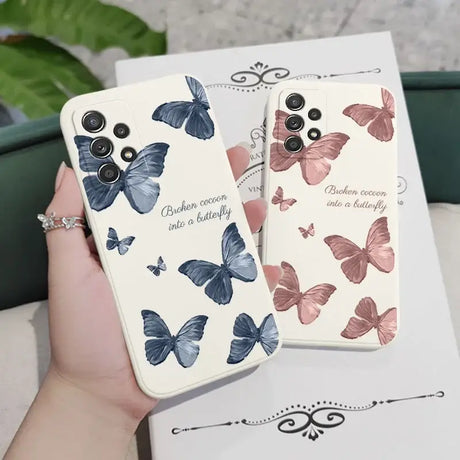 A woman holding a phone case with butterflies on it