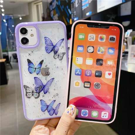 A woman holding up a phone case with butterflies on it