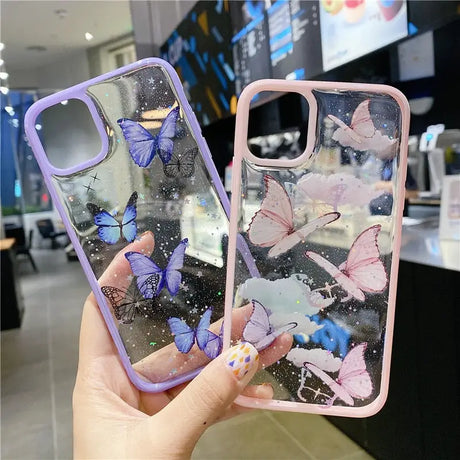 A woman holding a phone case with butterflies on it