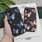 a woman holding a phone case with butterflies on it