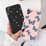 A woman holding a phone case with butterflies on it